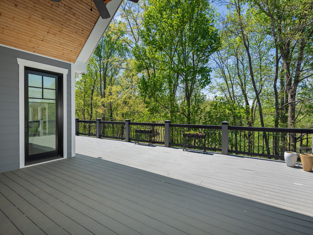 Covered back deck with tongue-and-groove ceiling and views into tranquil woods