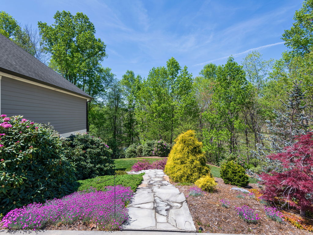 Vibrant flowering perennials, Japanese maple and manicured mulch beds