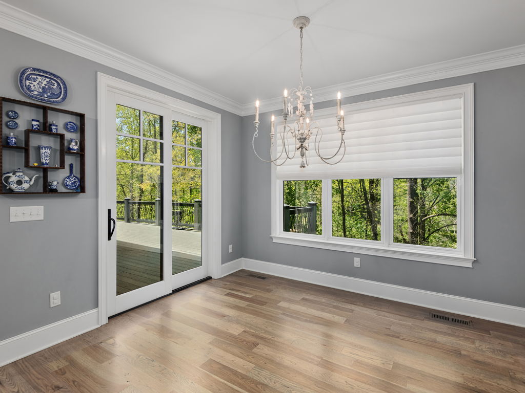 Primary bedroom suite featuring glass sliders opening to the covered rear deck