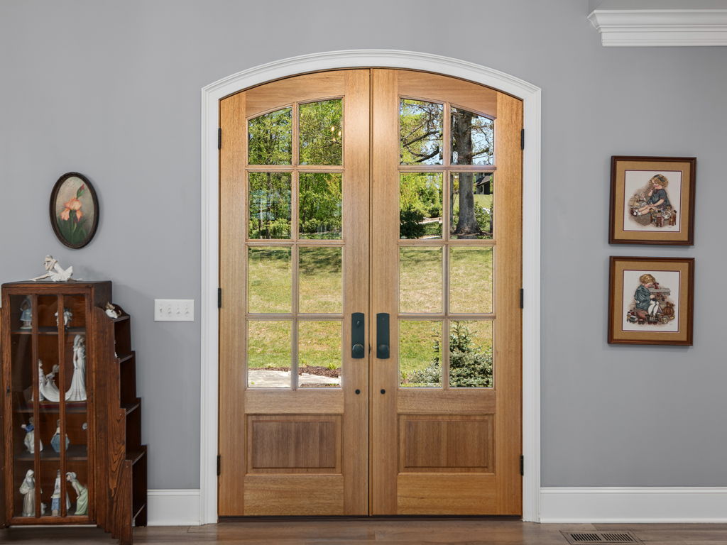 Craftsman double wood entry doors with arched transom window