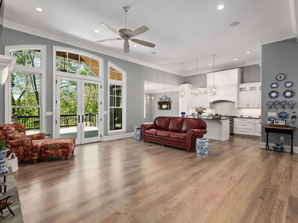 Seamless open-concept flow connecting living room, dining area, and kitchen