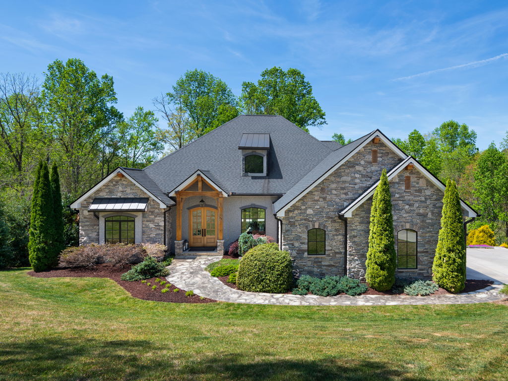 Front exterior elevation of 28 Falling Star Court showcasing stone and stucco architecture